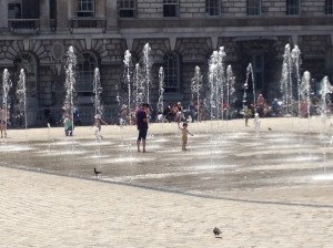 Children playing in fountain, King's College London
